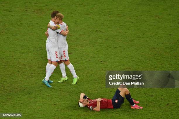 Joachim Andersen and Simon Kjaer of Denmark celebrate their side's victory as Tomas Soucek of Czech Republic looks dejected after the UEFA Euro 2020...