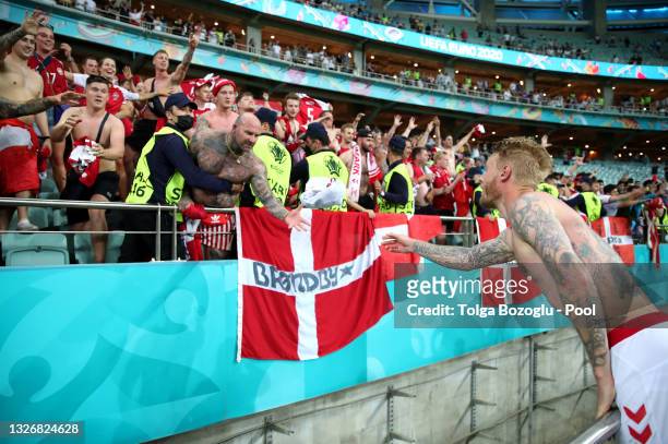 Simon Kjaer of Denmark celebrates their side's victory with a fan after the UEFA Euro 2020 Championship Quarter-final match between Czech Republic...