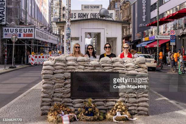 Tourists take a photo at Checkpoint Charlie, the best-known Berlin Wall crossing point between East Berlin and West Berlin during the Cold War, on...