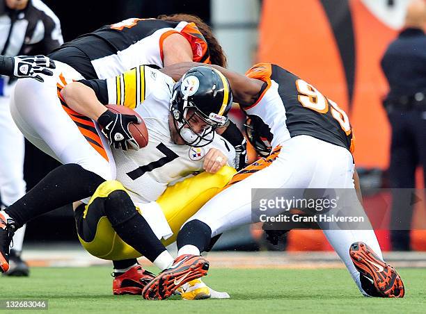 Domata Peko and Manny Lawson of the Cincinnati Bengals sacks quarterback Ben Roethlisberger of the Pittsburgh Steelers during play at Paul Brown...