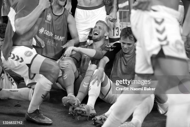 Kasper Schmeichel and Mikkel Damsgaard of Denmark celebrate with teammates after victory in the UEFA Euro 2020 Championship Quarter-final match...