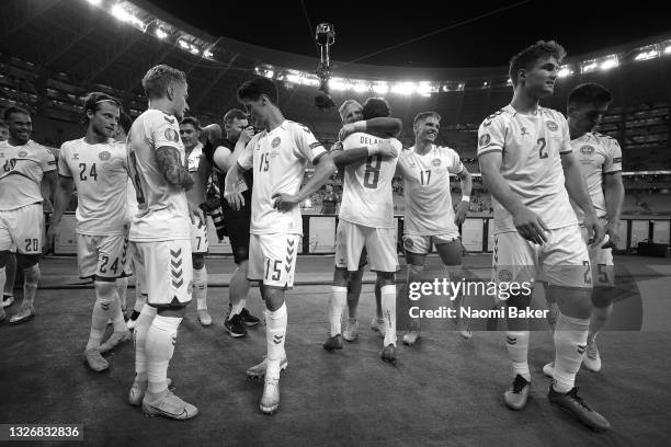 Kasper Schmeichel of Denmark hugs Thomas Delaney as they celebrate their side's victory after the UEFA Euro 2020 Championship Quarter-final match...