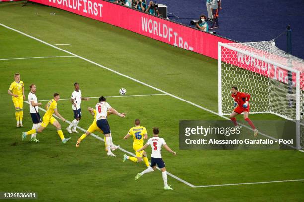 Harry Maguire of England scores their side's second goal past Georgiy Bushchan of Ukraine during the UEFA Euro 2020 Championship Quarter-final match...