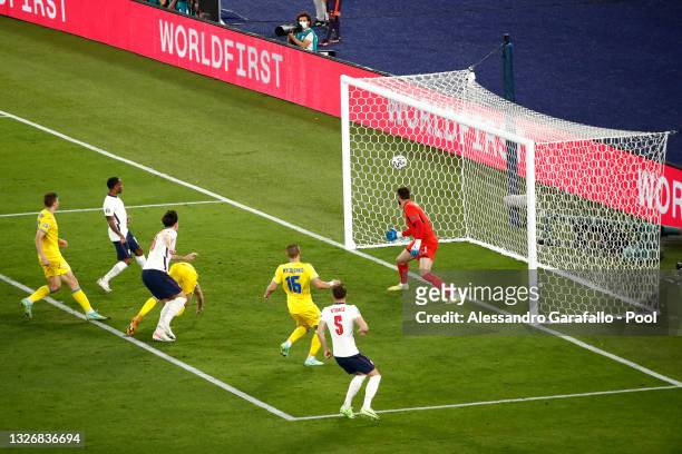 Harry Maguire of England scores their side's second goal past Georgiy Bushchan of Ukraine during the UEFA Euro 2020 Championship Quarter-final match...