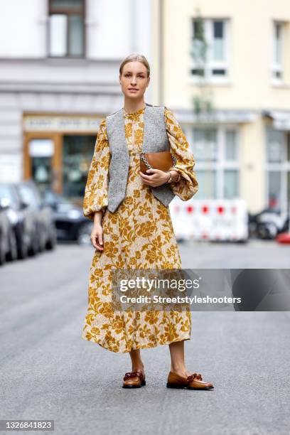 Influencer and model Marlies Pia Pfeifhofer wearing a cream colored maxi dress with long puff sleeves and mustard yellow floral print by Zara, a...