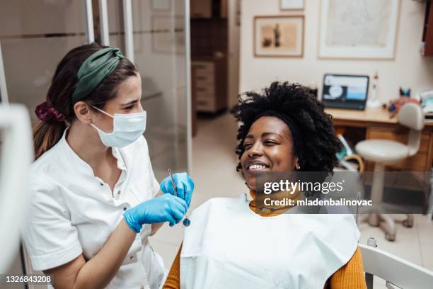 afro american woman visiting dentist - dental assistant stock pictures, royalty-free photos & images