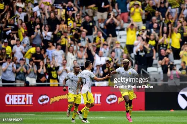 Gyasi Zardes of Columbus Crew celebrates his goal with Lucas Zelarayan and Darlington Nagbe in the first half during their game against the New...