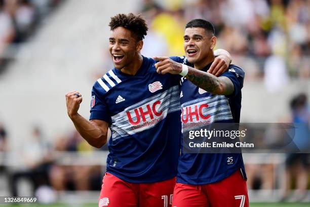 Tajon Buchanan and Gustavo Bou of New England Revolution celebrate Bou's goal in the first half during their game against the Columbus Crew at...