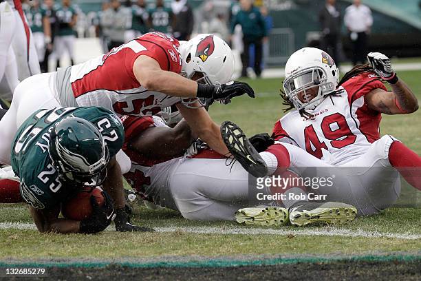 LeSean McCoy of the Philadelphia Eagles scores a touchdown in front of Stewart Bradley and Rashad Johnson of the Arizona Cardinals during the first...