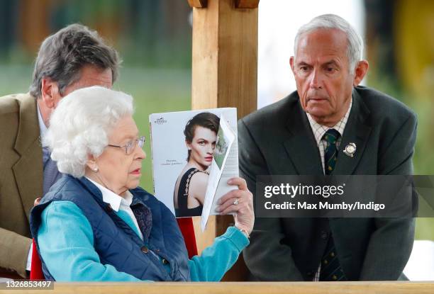 Queen Elizabeth II, accompanied by her stud groom Terry Pendry, watches her horse 'First Receiver' compete in and win the Retired Racehorses - RoR...