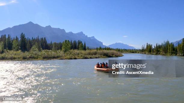 friends float down bow river in inflatable raft - river rafting stock pictures, royalty-free photos & images