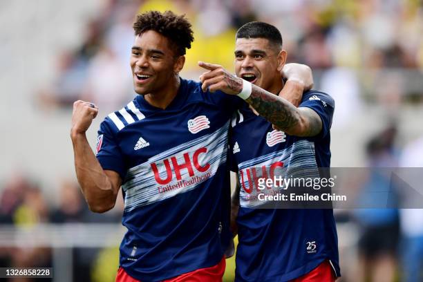 Tajon Buchanan and Gustavo Bou of New England Revolution celebrate Bou's goal in the first half during their game against the Columbus Crew at...