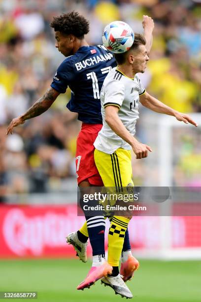 Pedro Santos of Columbus Crew and Tajon Buchanan of New England Revolution jump to head the ball in the first half during their game at Lower.com...