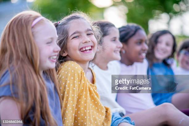 smiling elementary school children hanging out together - summer school stock pictures, royalty-free photos & images