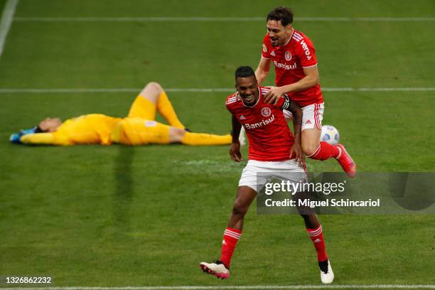 Edenilson of Internacional celebrates with teammate Mauricio after scoring a his team's first goal during a match between Corinthians and...