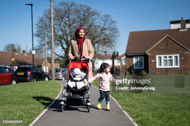 mid adult british asian woman exercising with young children - london not hipster not couple not love not sporty not businessman not businesswoman not young man no stockfoto's en -beelden