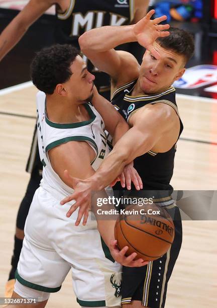 Bogdan Bogdanovic of the Atlanta Hawks defends Bryn Forbes of the Milwaukee Bucks during the second half in Game Six of the Eastern Conference Finals...