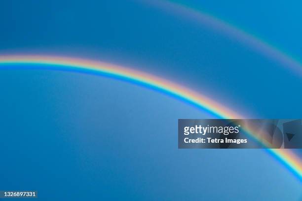 double rainbow on blue sky - rainbow sky stock pictures, royalty-free photos & images