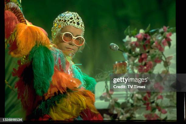 English pop/rock musician Elton John performing his song 'Crocodile Rock' on the set of The Muppet Show at Elstree Studios, Hertfordshire, circa...