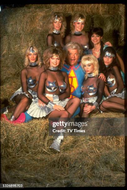 Comic actor Benny Hill with a group of 'Hill's Angels' during a sketch on The Benny Hill Show, circa 1983.