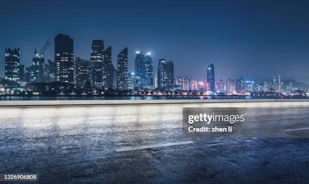 urban expressway in rainy night - city lights reflected on buildings speed stock pictures, royalty-free photos & images