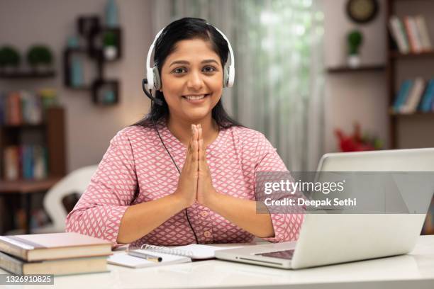 happy business women and teacher with headphones using laptop for video call:- stock photo - namaste greeting stock pictures, royalty-free photos & images