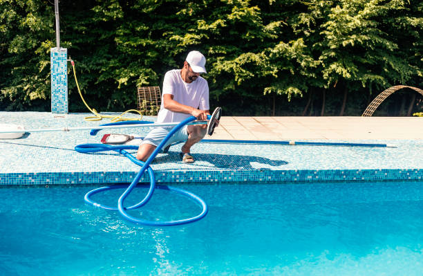 man cleaning the swimming pool