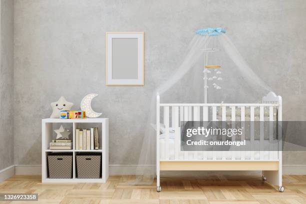 baby room interior with white crib and toys. empty picture frame on the wall. - nursery bedroom stockfoto's en -beelden