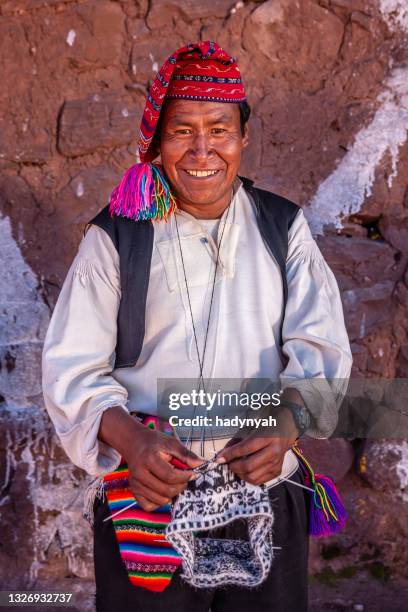 man knitting hat on taquile island, lake titicaca, peru - peruvian culture stock pictures, royalty-free photos & images