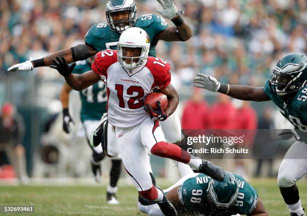 Andre Roberts of the Arizona Cardinals is pursued by Akeem Jordan, Mike Patterson and Brian Rolle of the Philadelphia Eagles during a game at Lincoln...