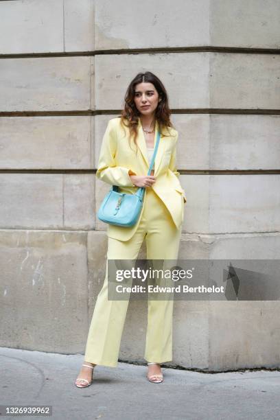 Ketevan Giorgadze @katie.one wears a lime suit oversized pastel yellow blazer jacket by Aspect, straight wide leg lime yellow pants by Aspect, a...
