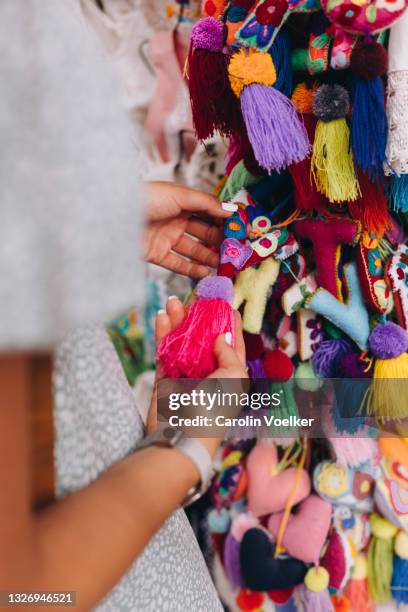close up of female hand choosing a souvenir - mexican street market stock pictures, royalty-free photos & images