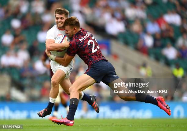 Harry Randall of England breaks past Christian Dyer of USA to for his team's seventh try during the Summer International Rugby Union match between...