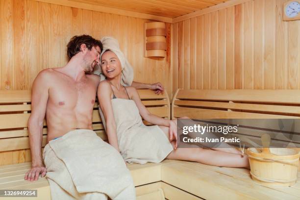 happy caucasian man and woman relaxing at the spa sauna - steam room stock pictures, royalty-free photos & images