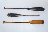 Photograph of three wooden oars hanging on a wall for decoration