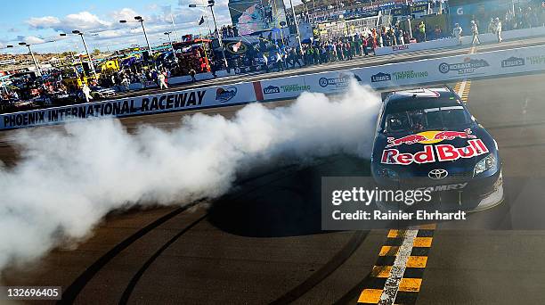 Kasey Kahne, driver of the Red Bull Toyota, celebrates with a burnout after winning the NASCAR Sprint Cup Series Kobalt Tools 500 at Phoenix...