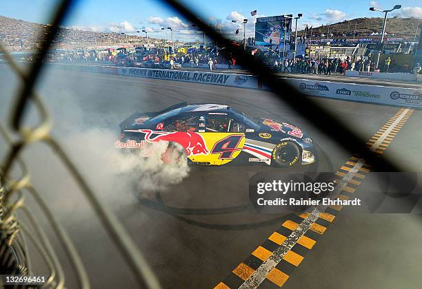 Kasey Kahne, driver of the Red Bull Toyota, celebrates with a burnout after winning the NASCAR Sprint Cup Series Kobalt Tools 500 at Phoenix...