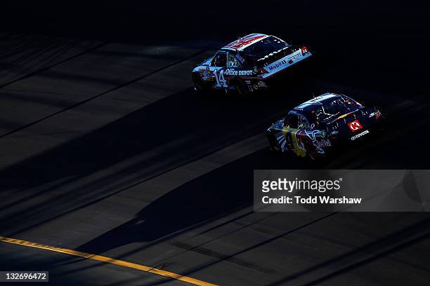 Tony Stewart, driver of the Office Depot/Mobil 1 Chevrolet, leads Kasey Kahne, driver of the Red Bull Toyota, during the NASCAR Sprint Cup Series...