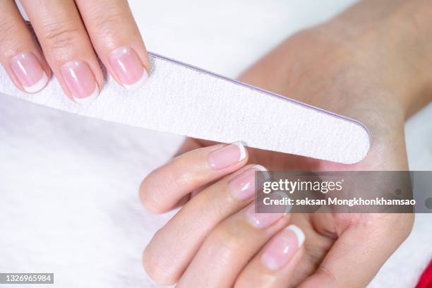 close up of beautiful female hands having manicure treatment. - französische maniküre stock-fotos und bilder
