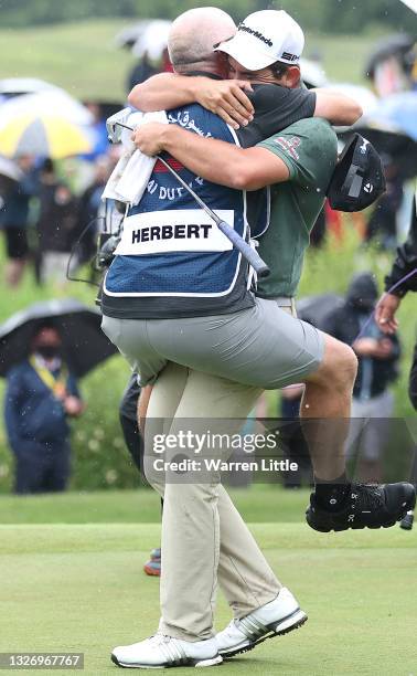 Lucas Herbert of Australia celebrates with caddie Nick Pugh after winning the Dubai Duty Free Irish Open at Mount Juliet Golf Club on July 04, 2021...