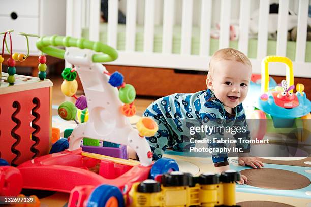 baby crawling with toys - baby toy stock pictures, royalty-free photos & images