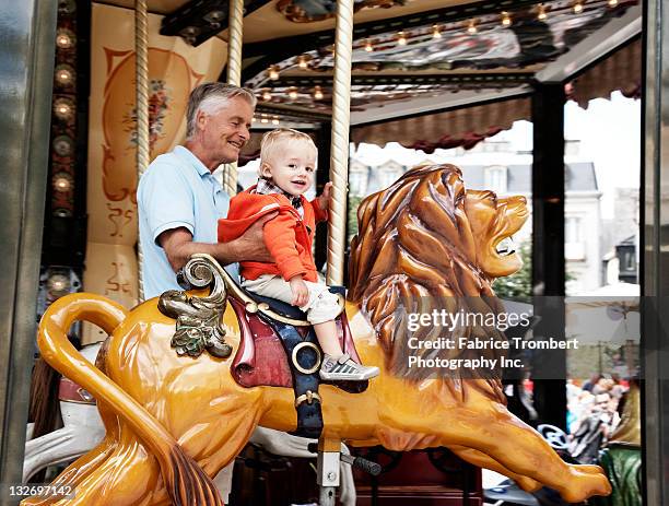 toddler on carousel - quimper fotografías e imágenes de stock