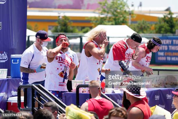 Mens division competitors participate in the 2021 Nathans Famous Fourth of July International Hot Dog Eating Contest at Coney Island on July 04, 2021...