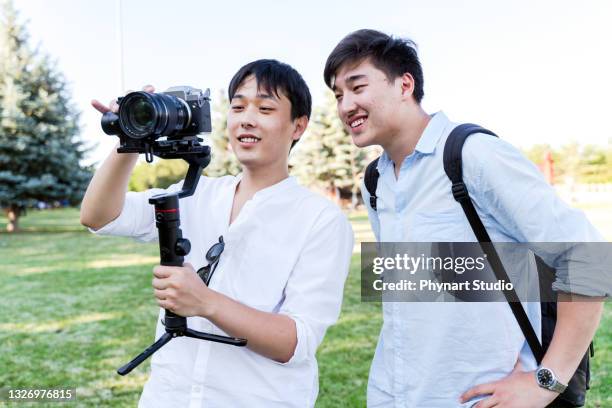 shot of a of business man being filmed and watching together - film director asian stock pictures, royalty-free photos & images