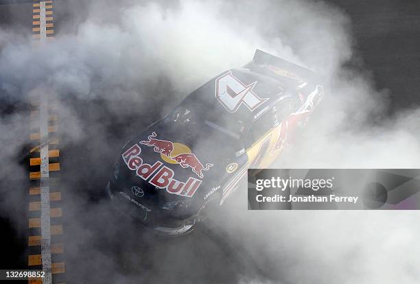 Kasey Kahne, driver of the Red Bull Toyota, celebrates with a burnout after winning the NASCAR Sprint Cup Series Kobalt Tools 500 at Phoenix...