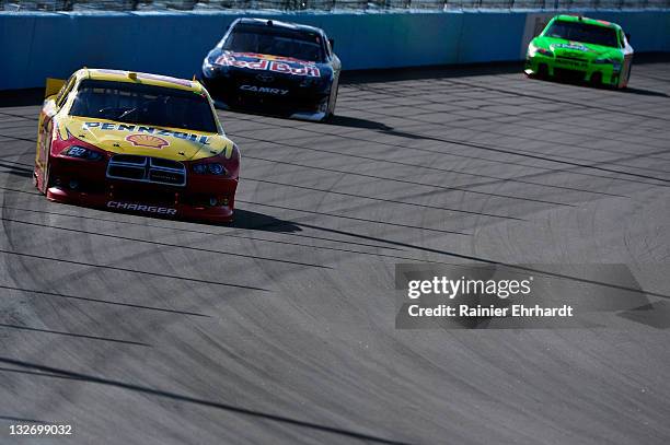 Kurt Busch, driver of the Shell/Pennzoil Dodge, leads Kasey Kahne, driver of the Red Bull Toyota, during the NASCAR Sprint Cup Series Kobalt Tools...