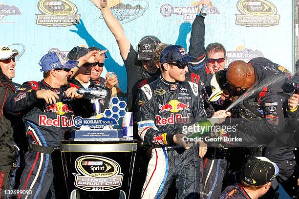 Kasey Kahne, driver of the Red Bull Toyota, celebrates with his team in victory lane after winning the NASCAR Sprint Cup Series Kobalt Tools 500 at...