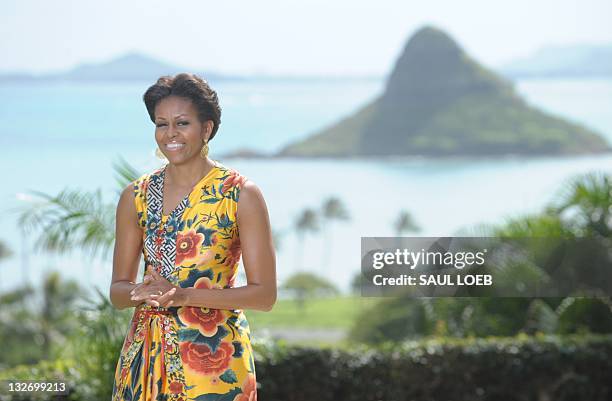 First Lady Michelle Obama smiles as she waits to greet the wives of various leaders as she hosts Asia-Pacific Economic Cooperation leaders' spouses...