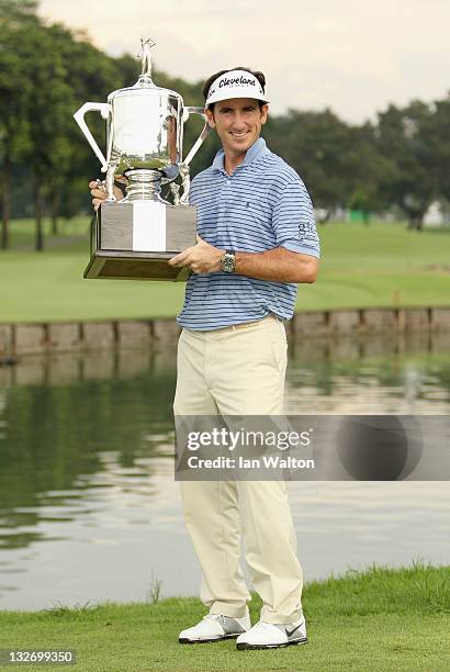 Gonzalo Fernandez-Castano of Spain celebrates with the trophy after winning the playoff on the 18th hole on day five of the Barclays Singapore Open...