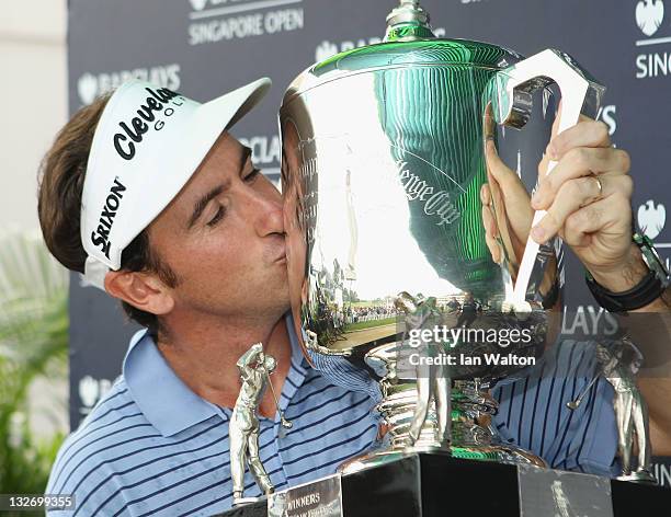 Gonzalo Fernandez-Castano of Spain celebrates with the trophy after winning the playoff on the 18th hole on day five of the Barclays Singapore Open...